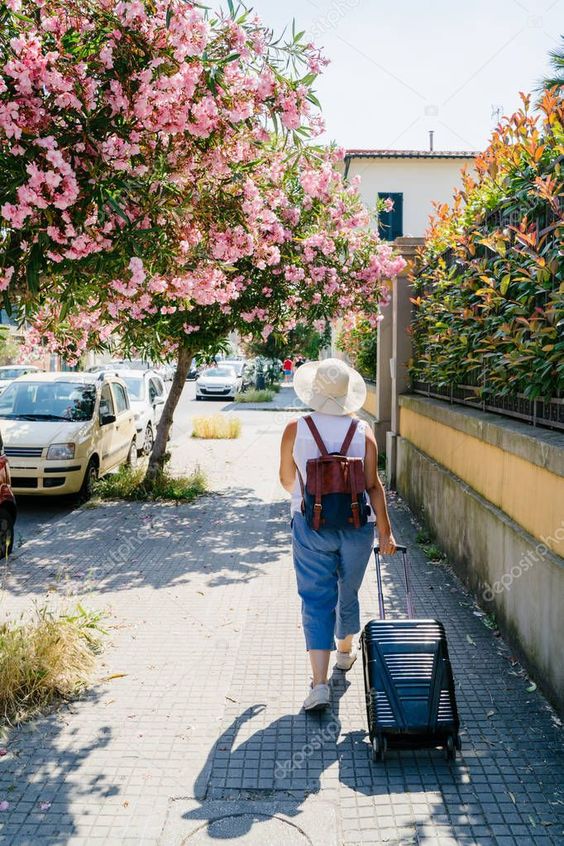 Woman in hat with suitcase and backpack is walking on city street in sunny summe , #ad, #suitcase, #backpack, #Woman, #hat #AD